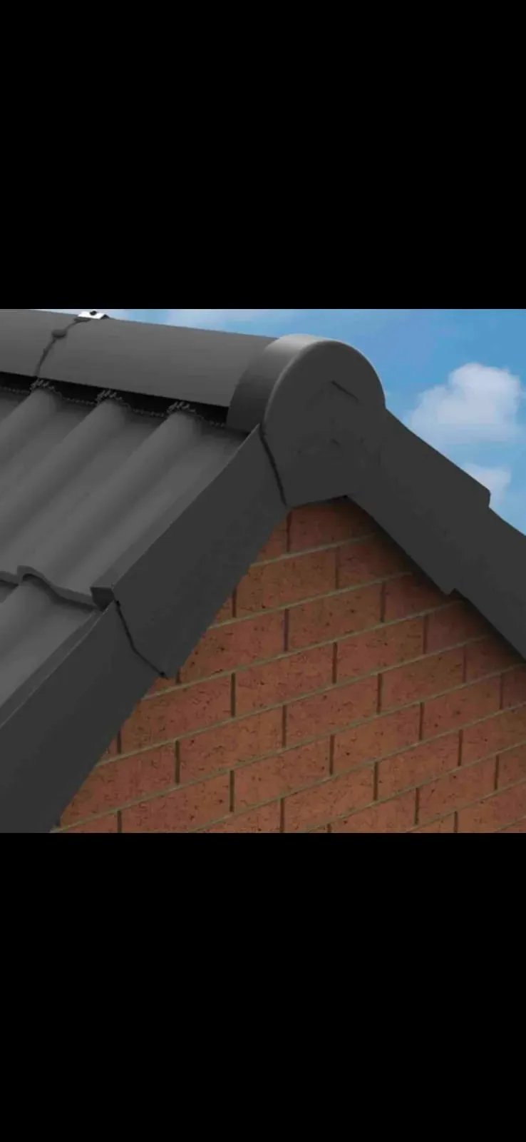 Close-up of a grey dry verge system installed on a roof's gable end, with brickwork visible